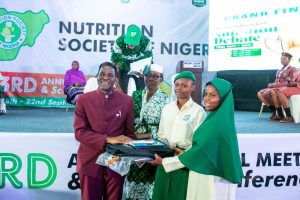 Director of Health and Nutrition ADF, Francis Aminu presents gifts to participating schools