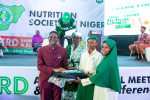 Director of Health and Nutrition, ADF Mr. Francis Aminu presenting gifts to participating schools