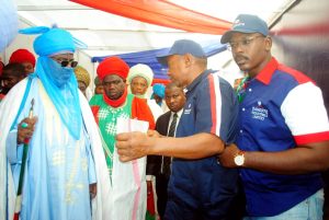 Dangote staff making presentation to the Emir of Kano Alhaji Aminu Ado Bayero during his visit to the Dangote pavilion